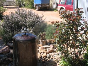 Pond, Fountain and glass sculpture made from river stones, railway sleepers an old Beazly hot water boiler. and a glass table top By Willem